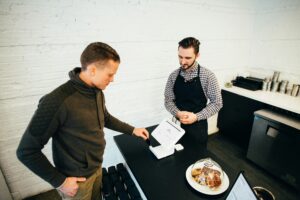 Man providing bakery with a tip for service