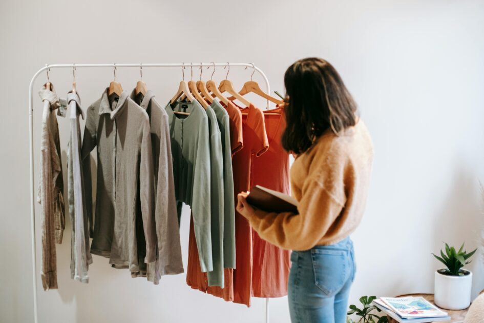 woman looking at different colored clothes